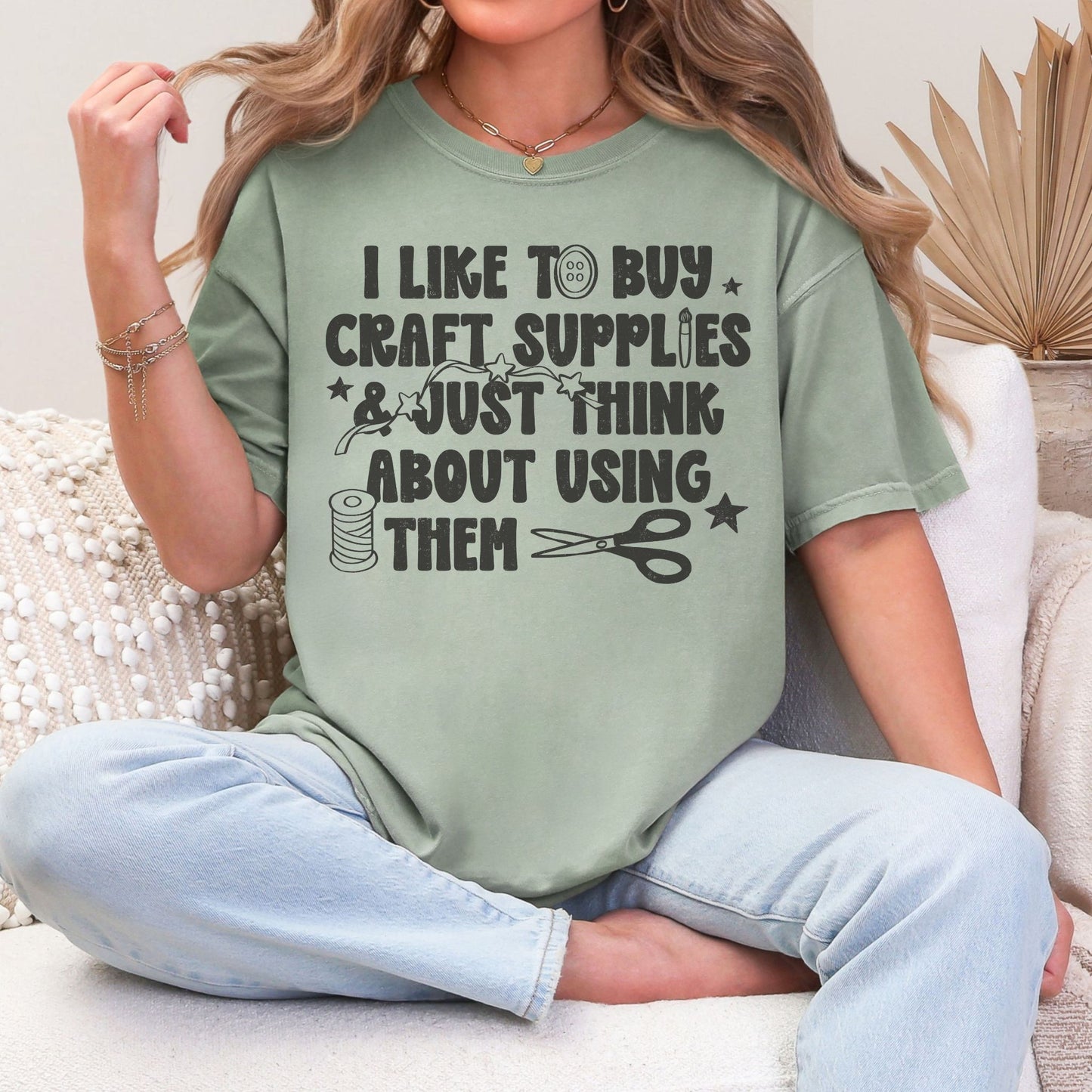 "I like to buy craft Supplies and just think about using them graphic on muted teal-green (bay) shirt.