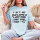 Model is wearing a Comfort Colors 1717 shirt in soft medium blue (chambray) featuring a funny craft-themed design that reads "I Like to Buy Craft Supplies & Just Think About Using Them" with sewing-inspired graphics including thread, scissors, stars, and buttons.