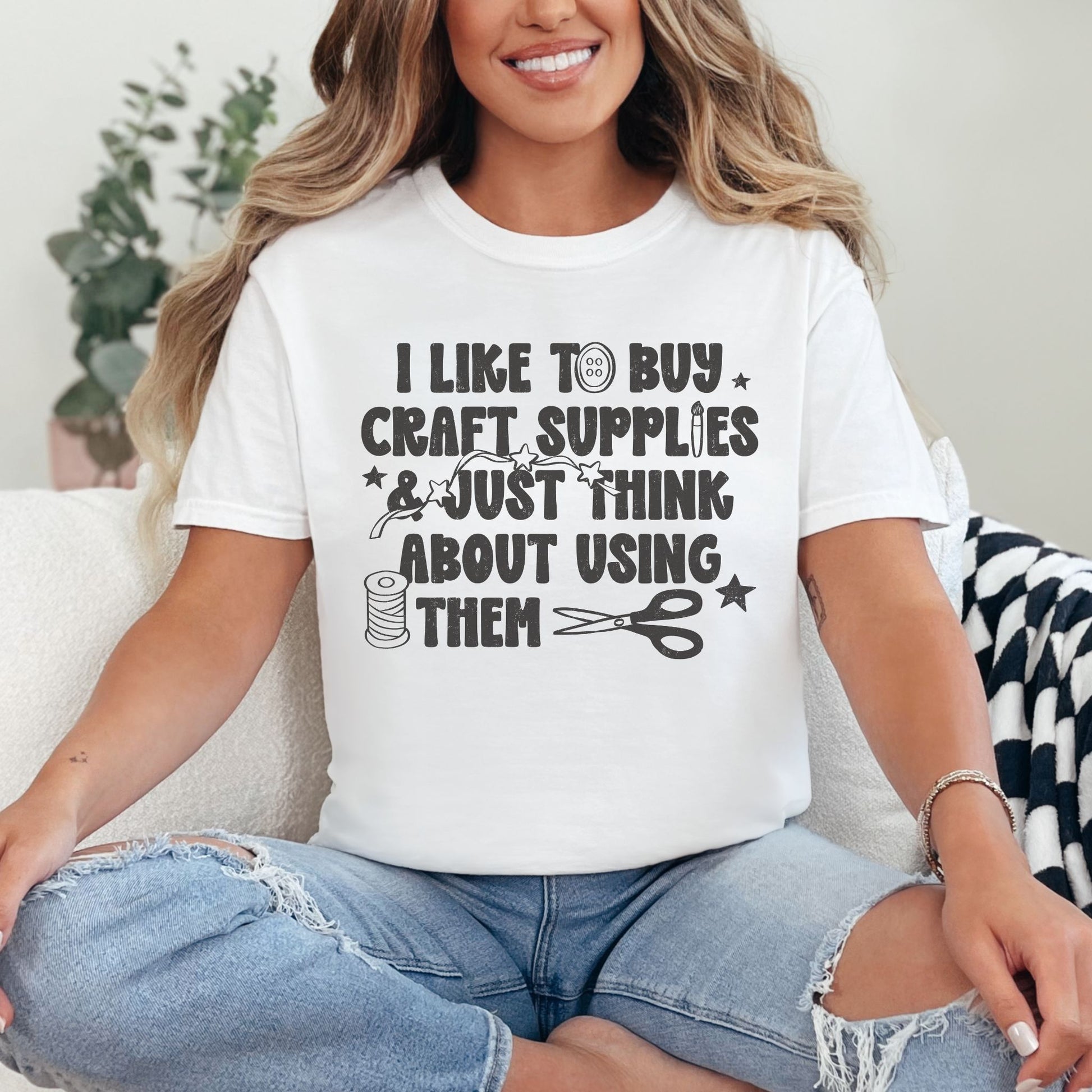"I like to buy craft Supplies and just think about using them. graphic on a white shirt.