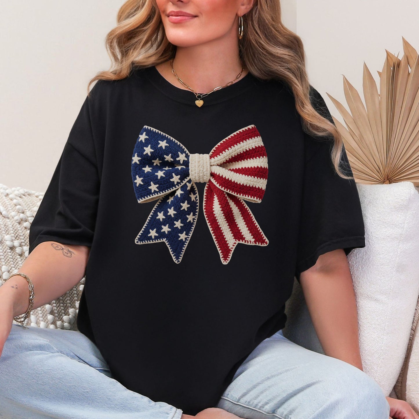 Faux Crochet American Flag Bow" graphic on a black T-Shirt.