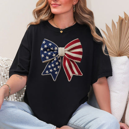 Faux Crochet American Flag Bow" graphic on a black T-Shirt.