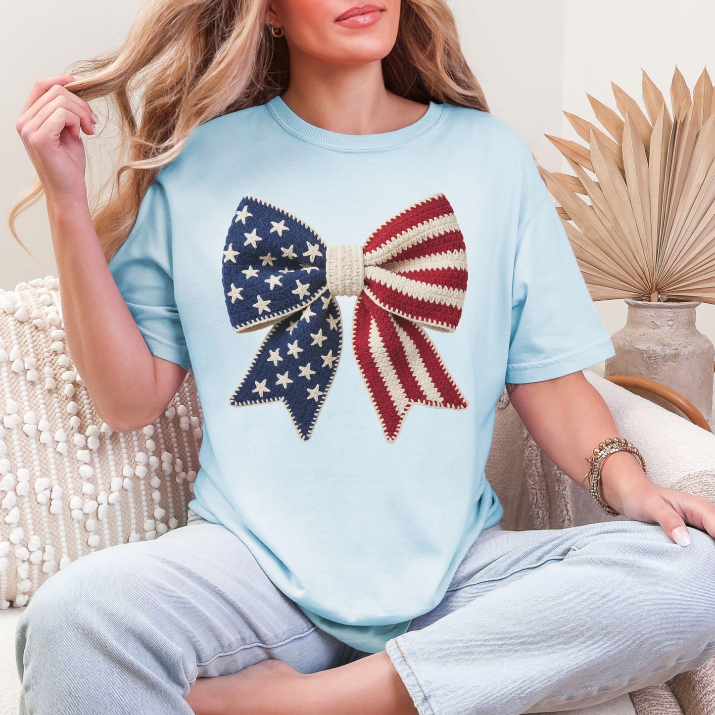 Faux Crochet American Flag Bow" graphic on soft medium blue (chambray) T-Shirt.