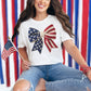 Model is wearing a Comfort Colors 1717 T-shirt in bright white (white) featuring a faux crochet American flag bow design with stars and stripes in a handmade-inspired style.