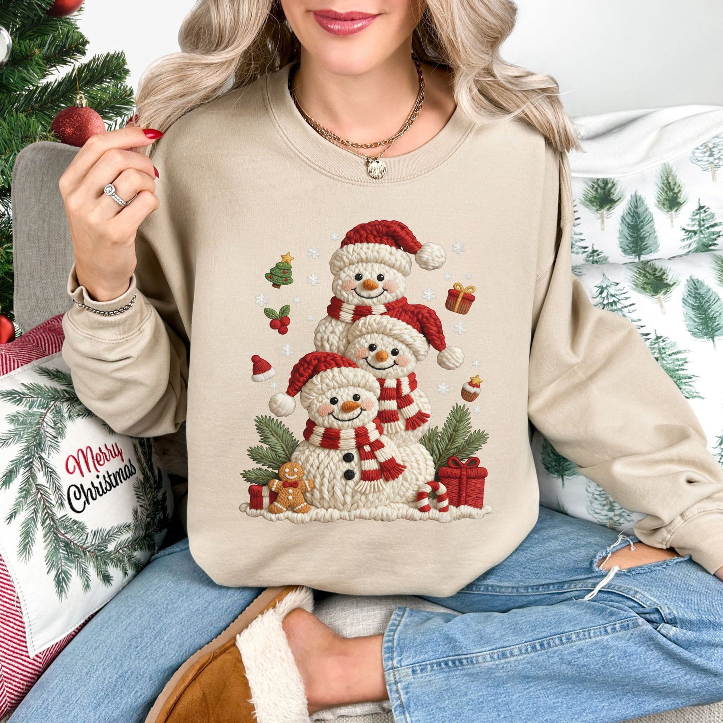 "Christmas Crochet Snowmen" graphic on a Gildan 18000 Sweatshirt in the color light beige (sand).