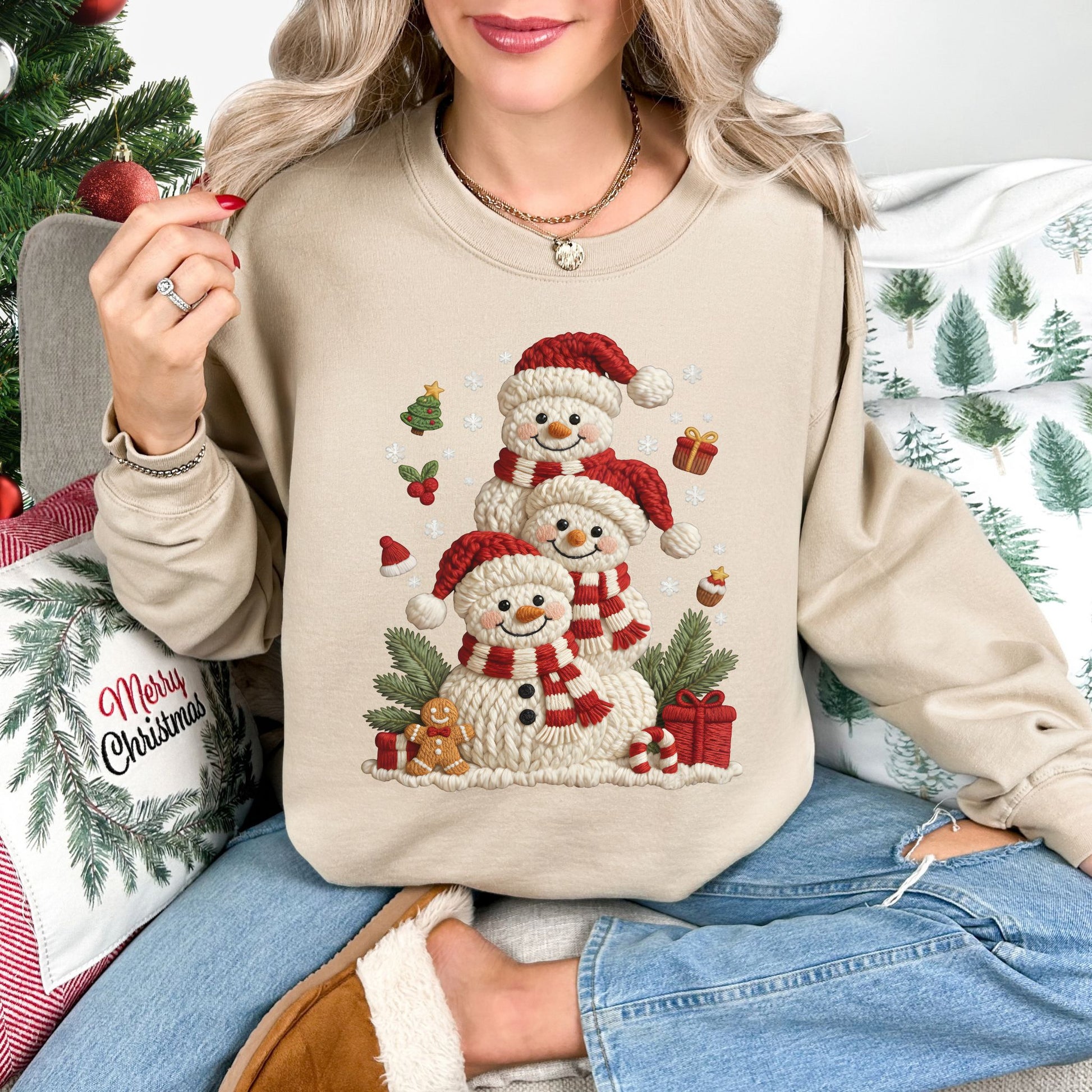 "Christmas Crochet Snowmen" graphic on a Gildan 18000 Sweatshirt in the color light beige (sand).