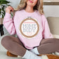 Cross Stitch Home Body graphic on soft pale pink (light pink) sweatshirt.