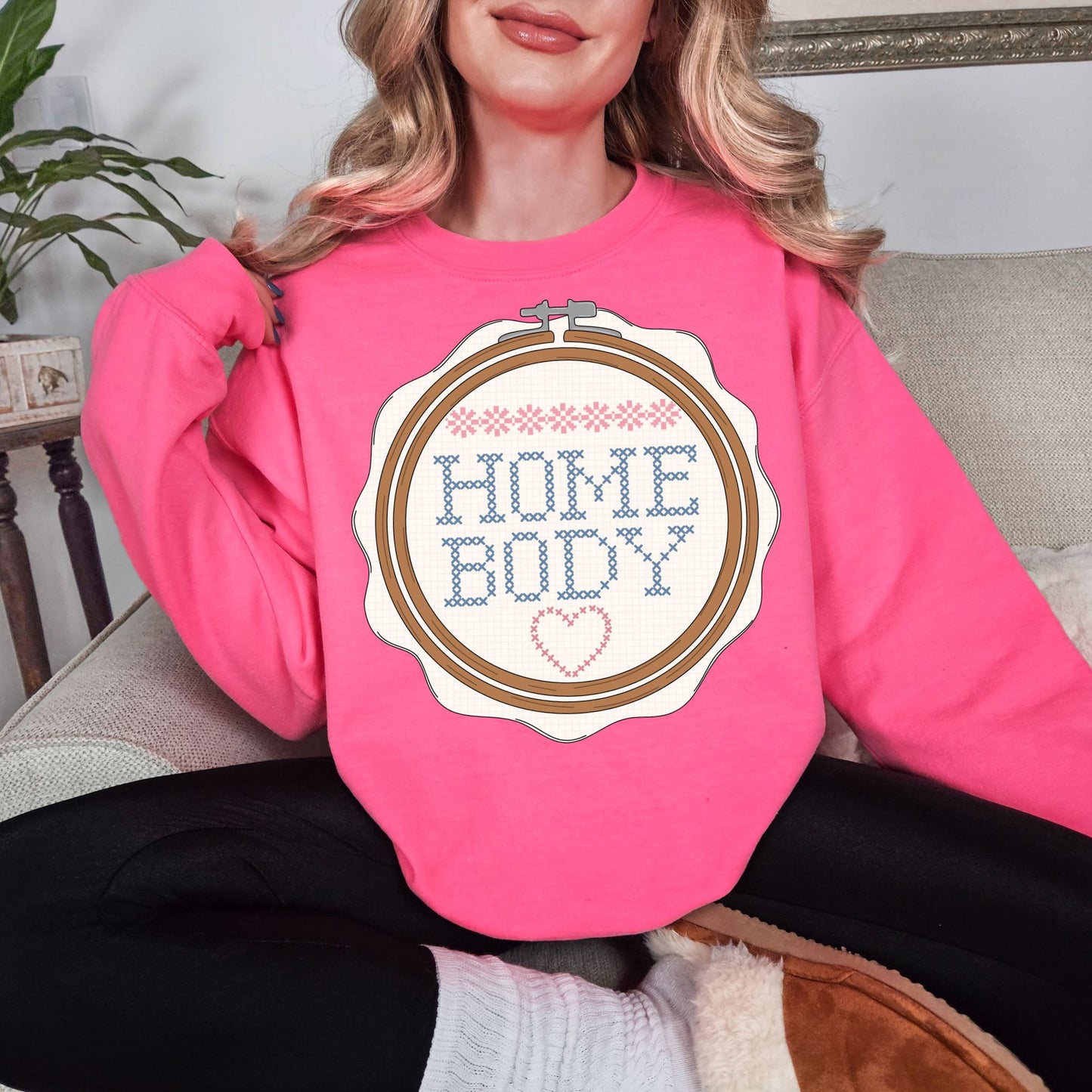Cross Stitch Home Body graphic on fluorescent bright pink (safety pink) sweatshirt.