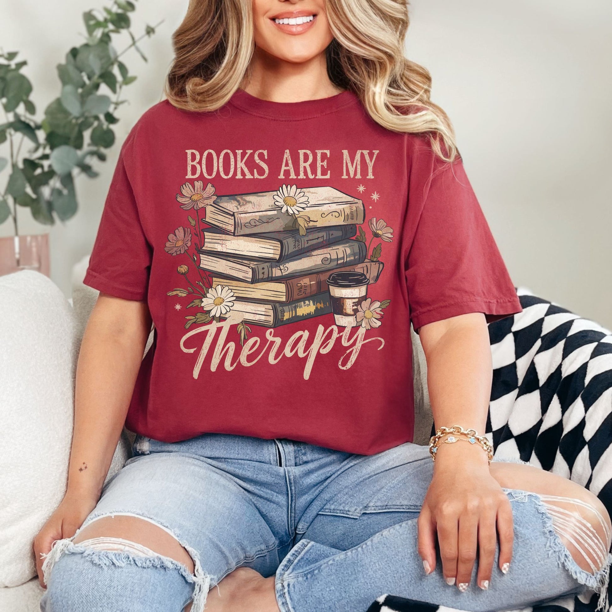 "Distressed Books Are My Therapy" graphic on muted brick red (chili) T-Shirt.