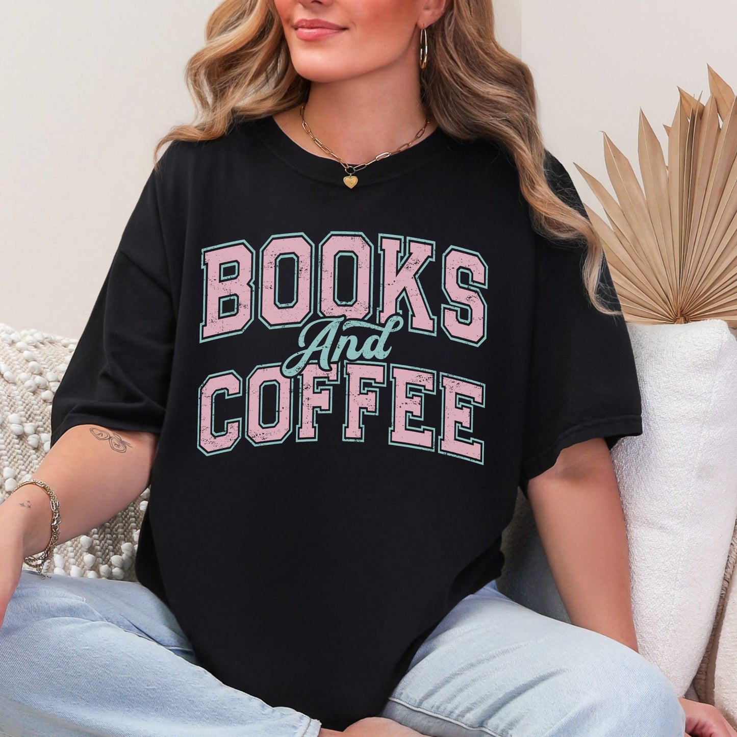 "Distressed Books and Coffee" graphic on a black T-Shirt.