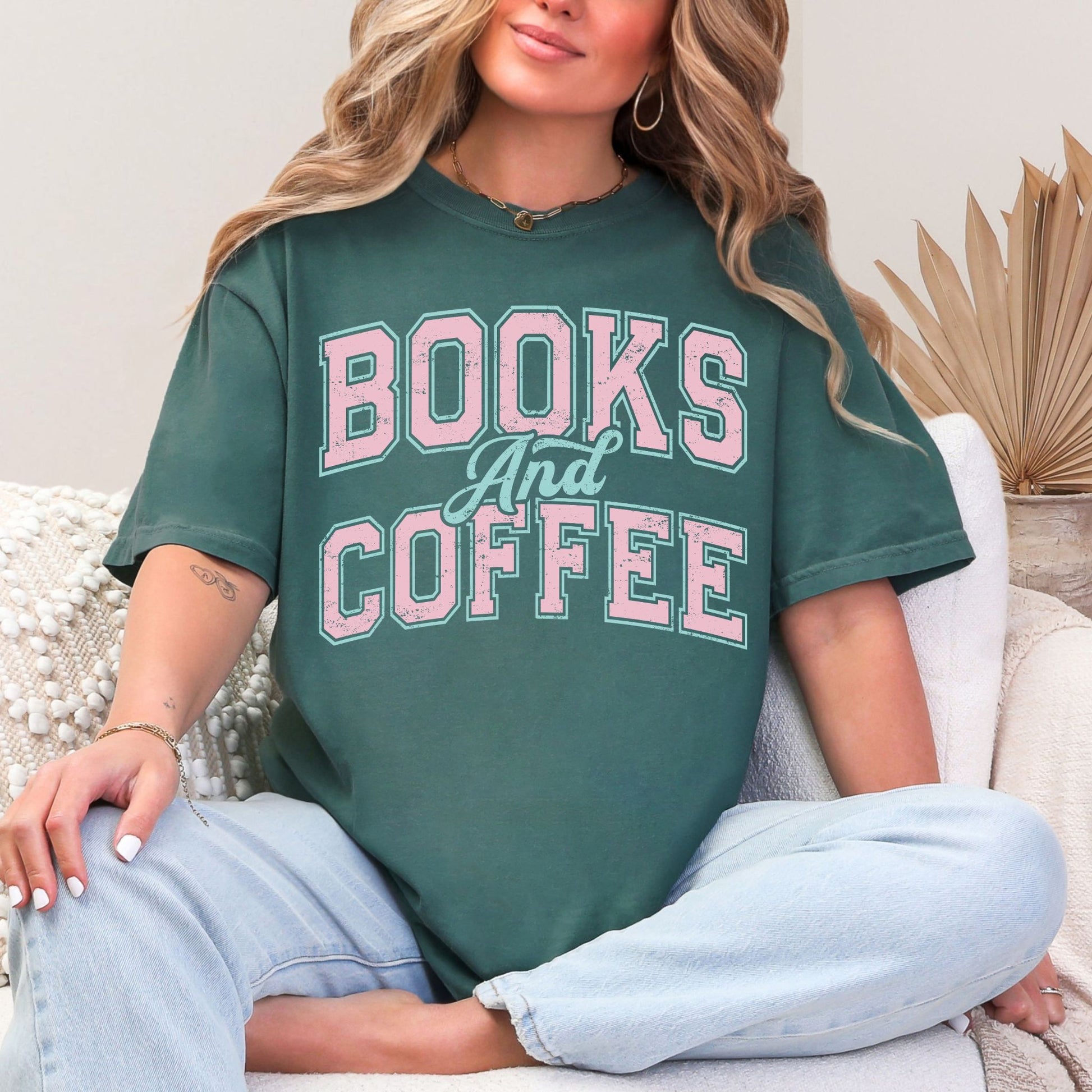 "Distressed Books and Coffee" graphic on muted blue-green (blue spruce) T-Shirt.