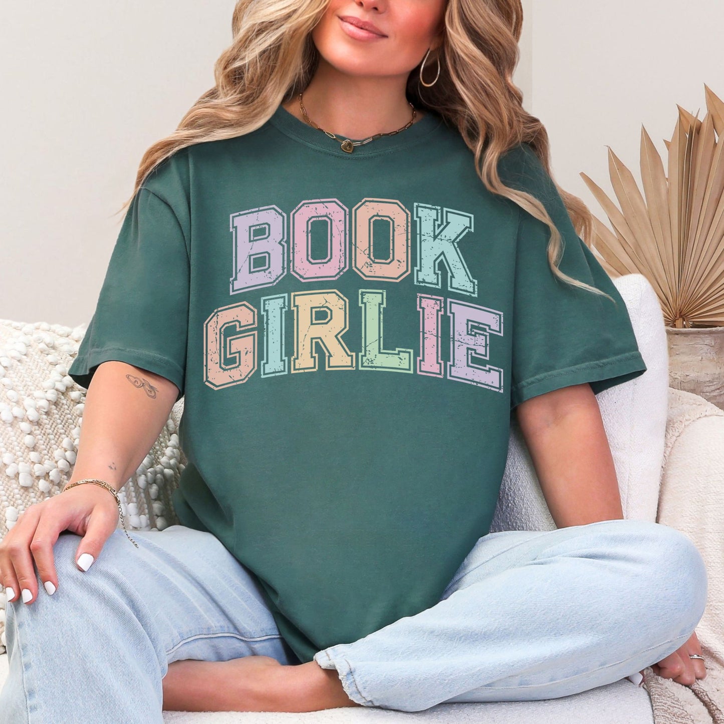 "Distressed Pastel Book Girlie" graphic on muted blue-green (blue spruce) t-shirt.