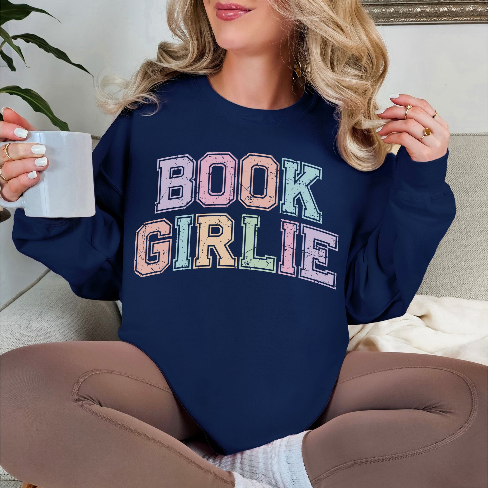 "Distressed Pastel Book Girlie" graphic on deep navy blue (navy) sweatshirt.