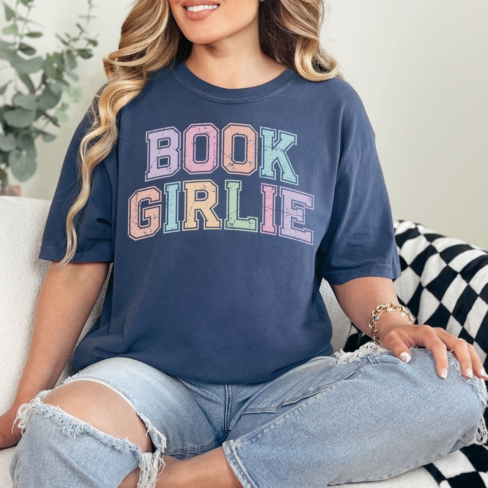 "Distressed Pastel Book Girlie" graphic on deep navy blue (navy) t-shirt.