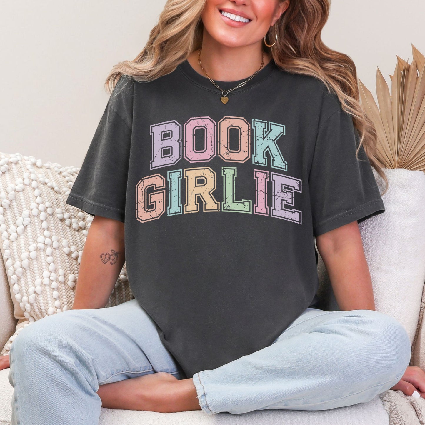 "Distressed Pastel Book Girlie" graphic on dark charcoal gray (pepper) t-shirt.
