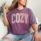 "Distressed Pastel Cozy" graphic on plain-language color deep berry pink (berry) T-shirt