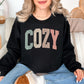 "Distressed Pastel Cozy" graphic on deep black (black) Sweatshirt.