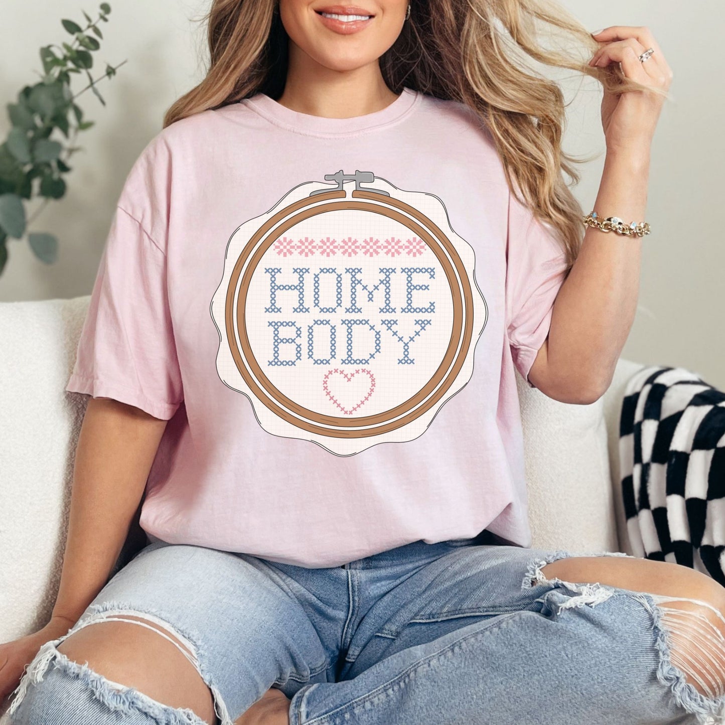 “Embroidery Hoop Home Body" graphic on soft pink (blossom) t-shirt.”