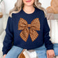 Model wearing a Gildan 18000 sweatshirt in dark blue (navy) featuring a large brown-and-cream gingham bow with a fabric-inspired textured appearance.
