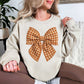 “Fall Gingham Bow" graphic on light beige (sand) Gildan 18000 Sweatshirt.