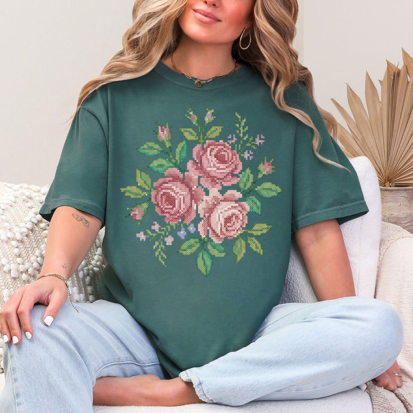 "Faux Cross Stitch Roses" graphic on muted blue-green (blue spruce) t-shirt.