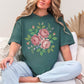 "Faux Cross Stitch Roses" graphic on muted blue-green (blue spruce) t-shirt.