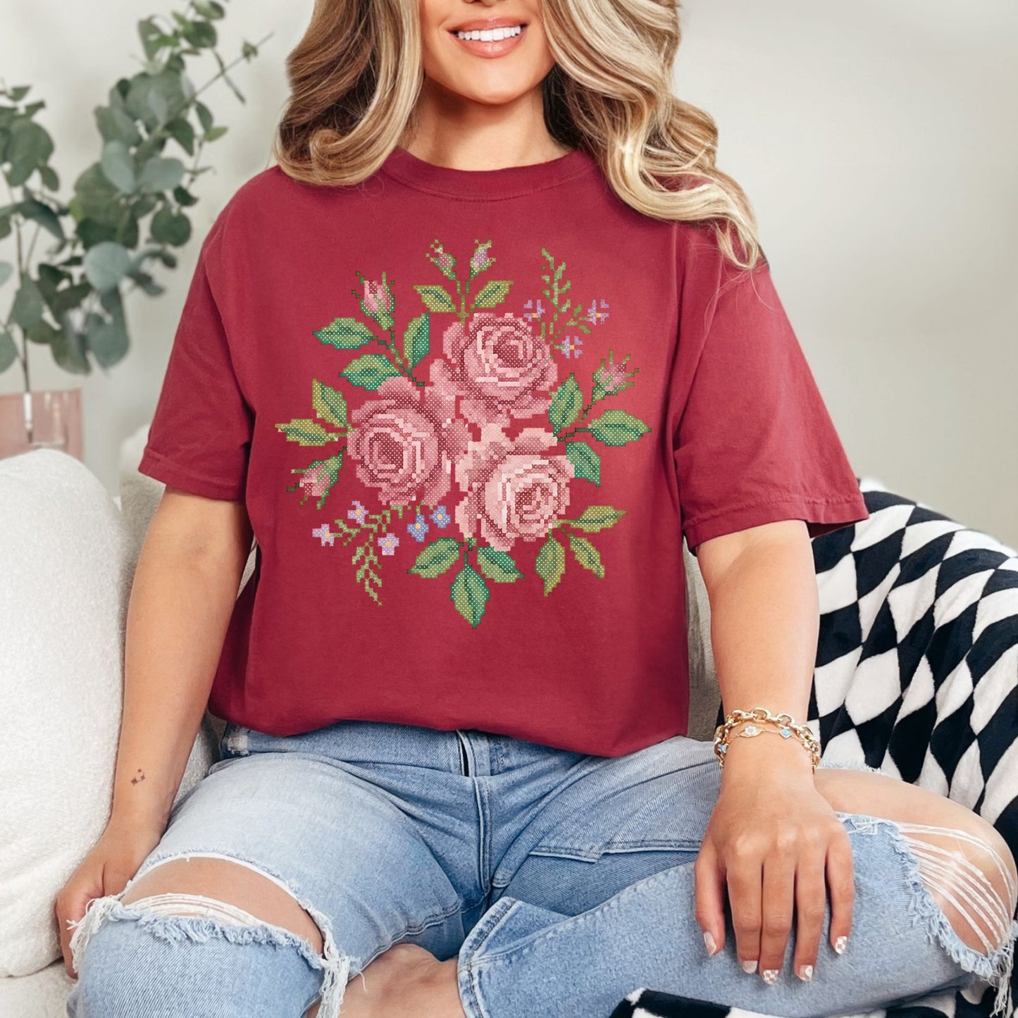 "Faux Cross Stitch Roses" graphic on muted brick red (chili) t-shirt.