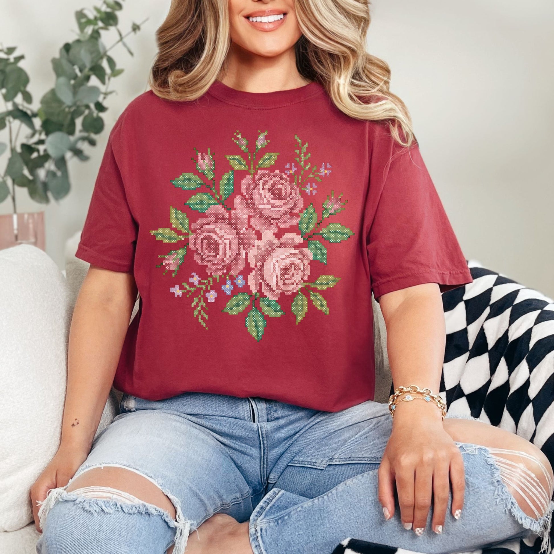 "Faux Cross Stitch Roses" graphic on muted brick red (chili) t-shirt.