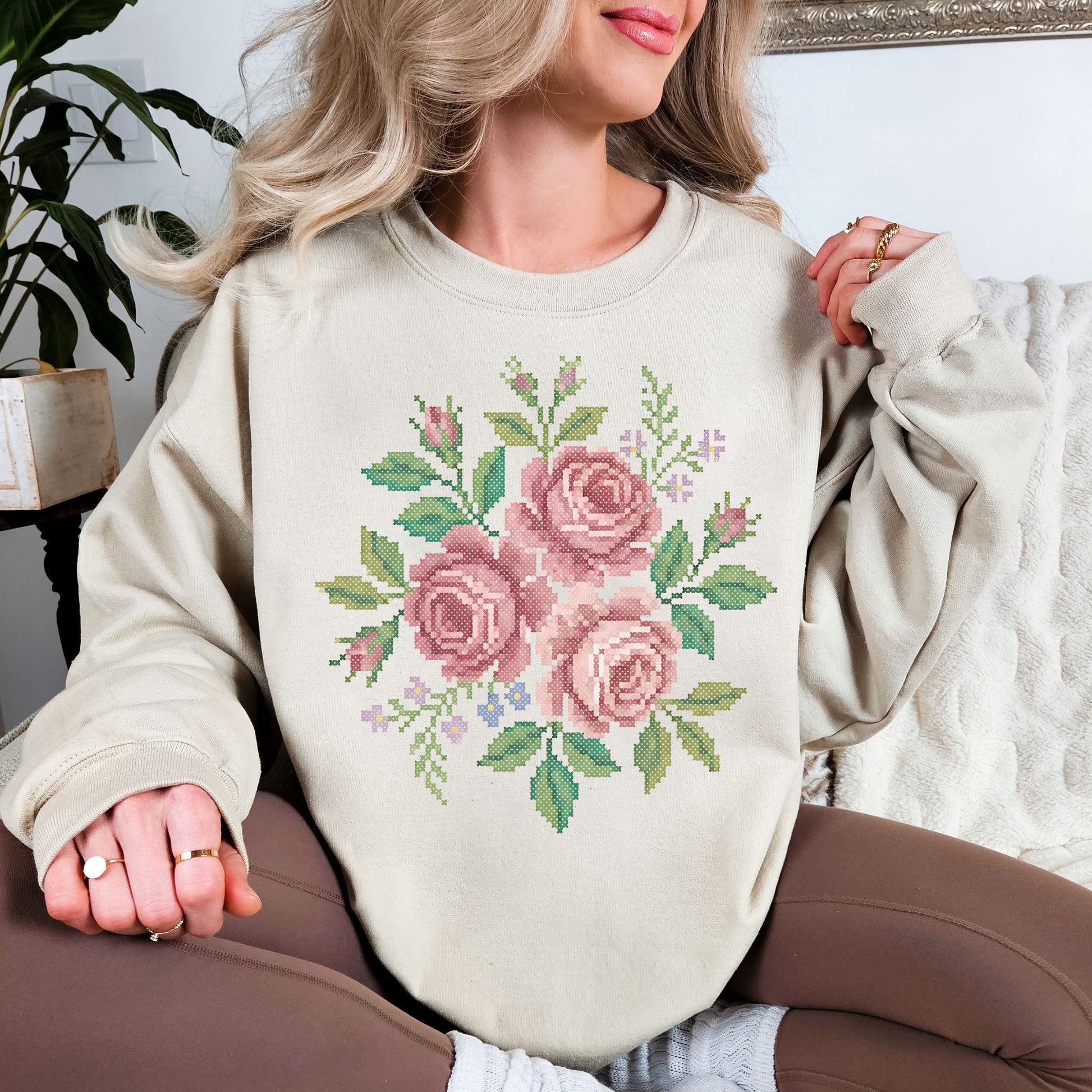 "Faux Cross Stitch Roses" graphic on light warm beige (sand) sweatshirt.