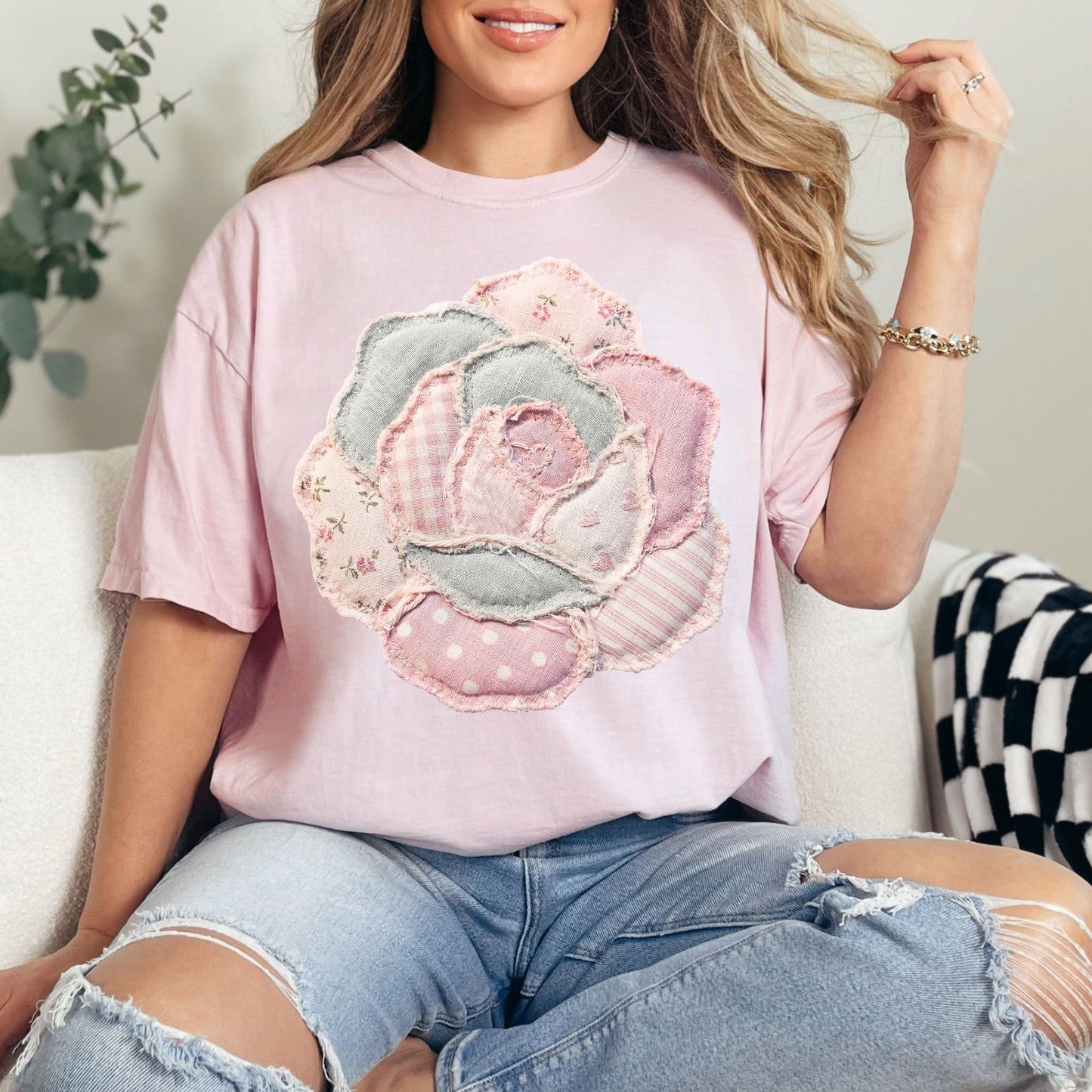 Model wearing Comfort Colors 1717 T shirt in soft pink (blossom) featuring a faux patchwork-style rose made of layered fabric-inspired patterns including florals, gingham, stripes, and polka dots in pastel pink, cream, and soft gray tones. The design is printed to resemble fabric patchwork and is not real stitched or textured material.