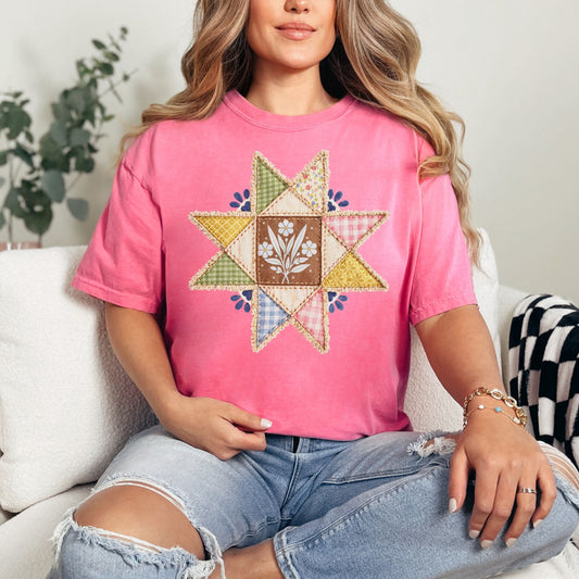 Model wearing a Comfort Colors T-Shirt in bright raspberry pink (crunchberry) featuring a faux quilted star patchwork graphic.