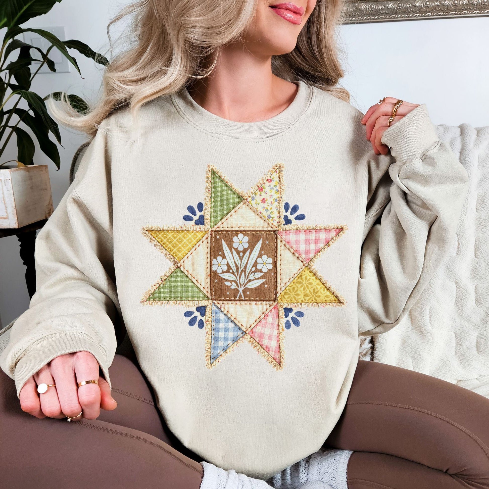 “Faux quilted Star" graphic on light warm beige (sand) Sweatshirt.