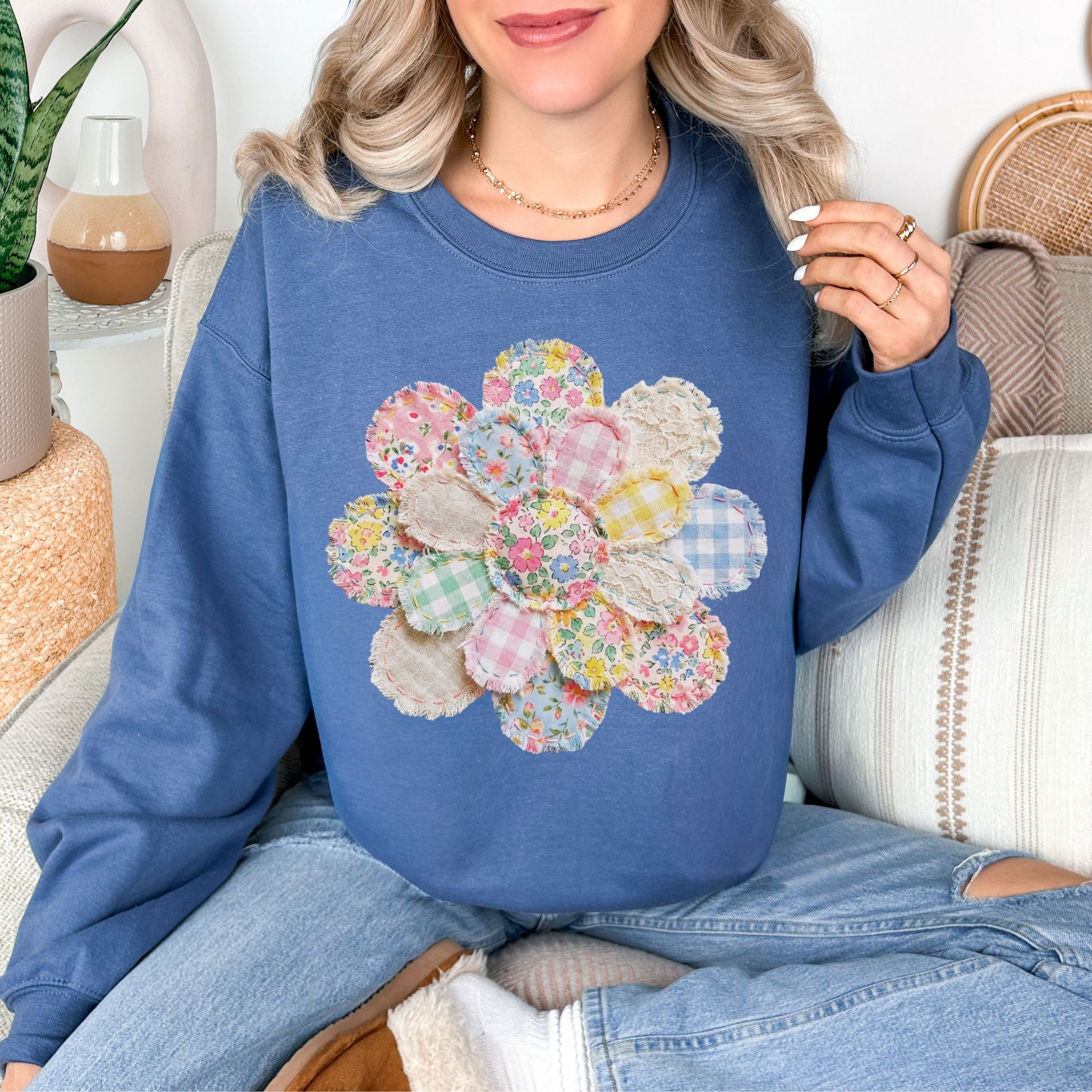 "Faux Spring Patchwork Flower" graphic on rich medium-dark blue (indigo blue) Sweatshirt.