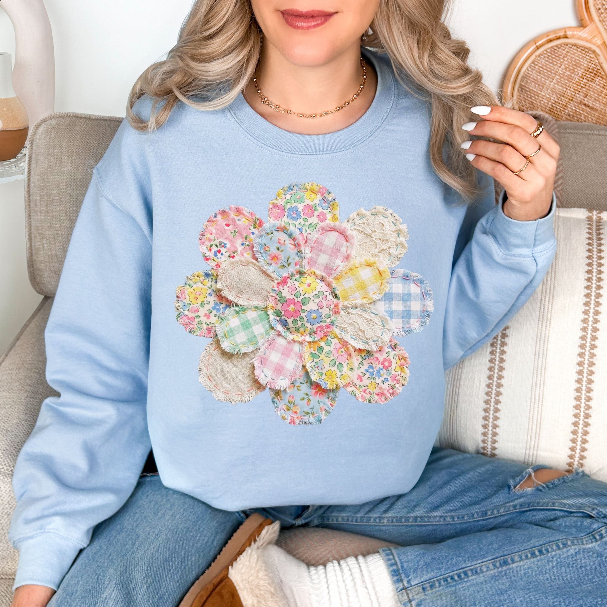 "Faux Spring Patchwork Flower" graphic on pale soft blue (light blue) Sweatshirt.