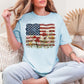 "Floral American Flag Faux Paint" on soft medium blue (chambray) T-Shirt.