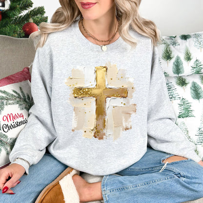 "Gold Christmas Cross" graphic on very light gray (ash) Gildan 18000 Sweatshirt.