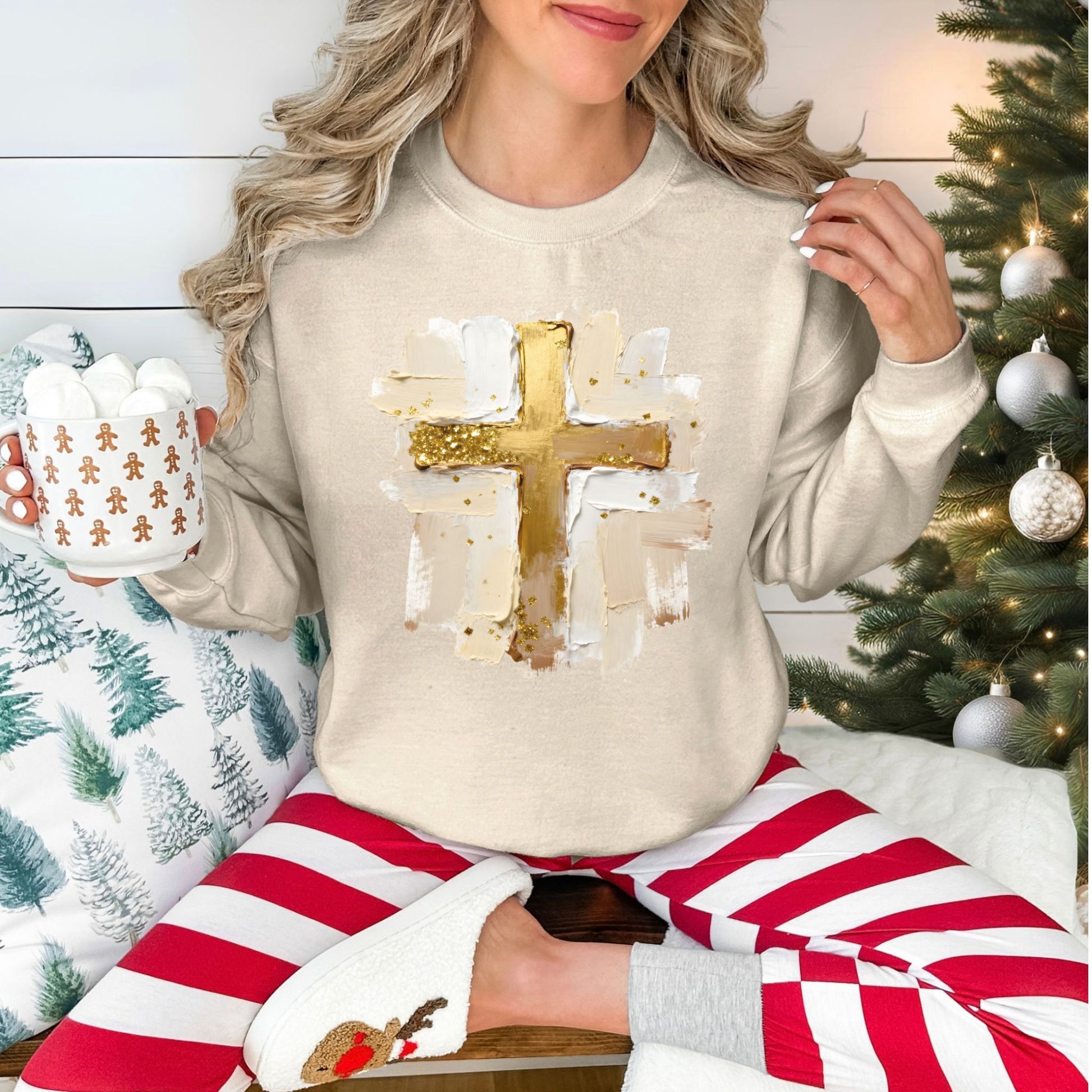 "Gold Christmas Cross" graphic on a light beige (sand) Gildan 18000 Sweatshirt.
