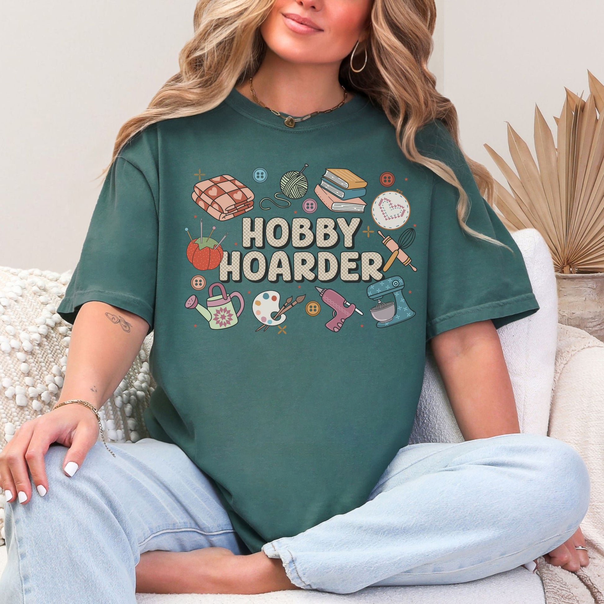 "Hobby Hoarder" graphic on muted blue-green (blue spruce) t-shirt.