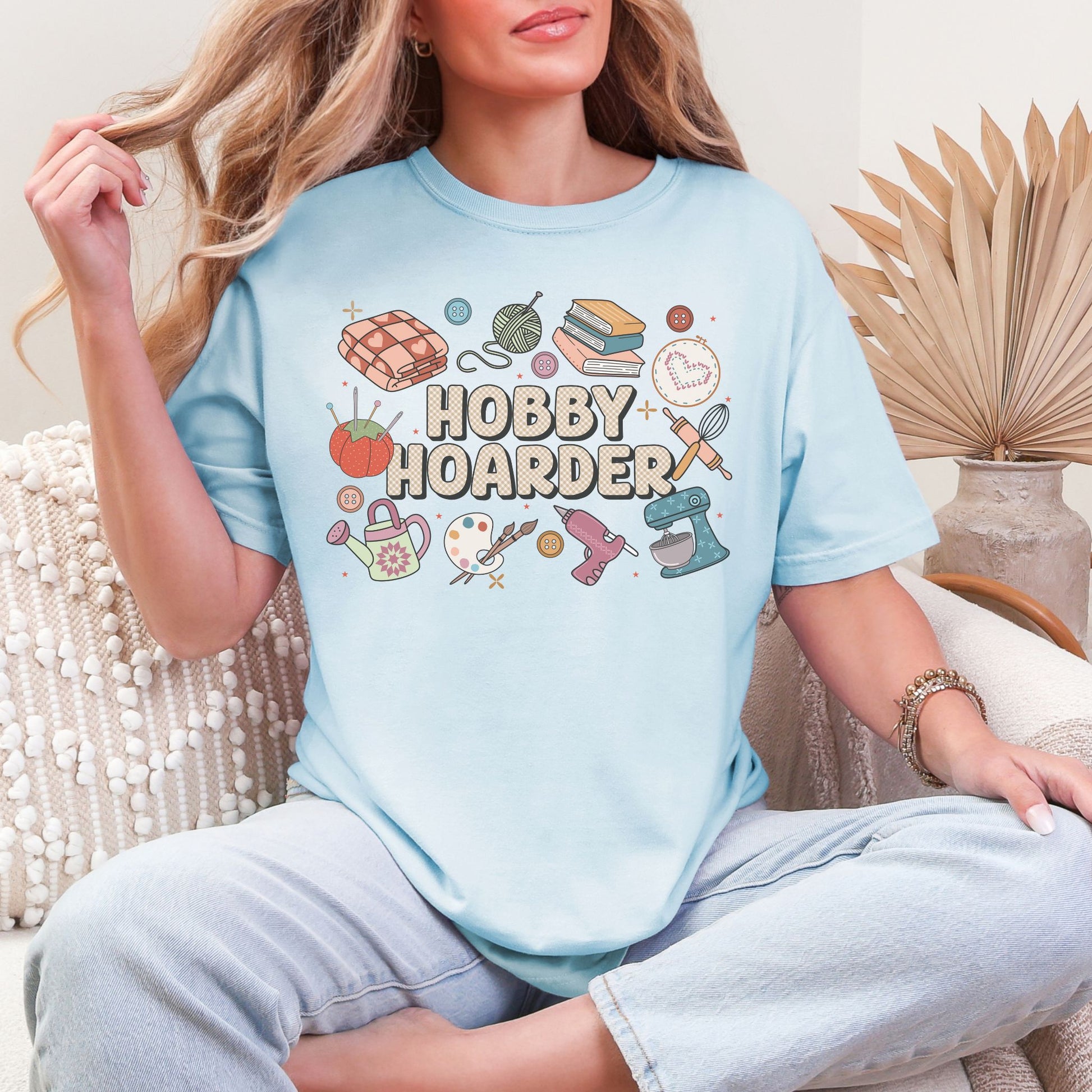 "Hobby Hoarder" graphic on soft medium blue (chambray) t-shirt.