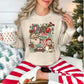 "Holly Jolly Distressed collage" on a light beige (sand) Gildan 18000 Sweatshirt.