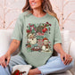 "Holly Jolly Collage" in muted teal-green (bay) on a Comfort colors 1717 T-shirt.