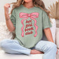"Hot girl book club" graphic on a muted teal-green (bay) t-shirt.