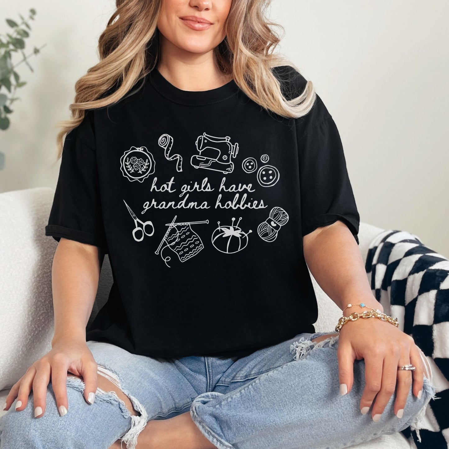 "Hot girls have grandma hobbies" graphic on a black t-shirt.