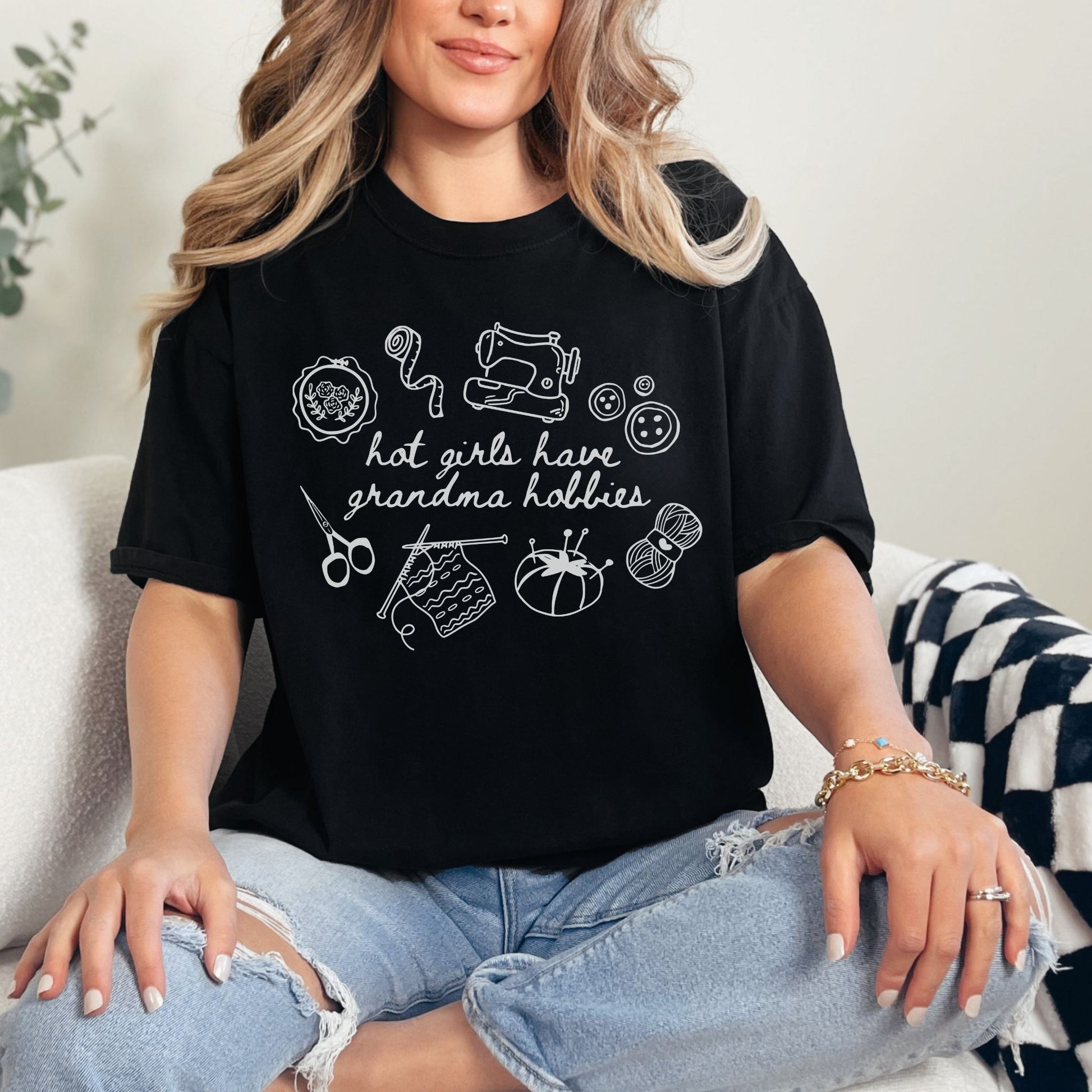 "Hot girls have grandma hobbies" graphic on a black t-shirt.