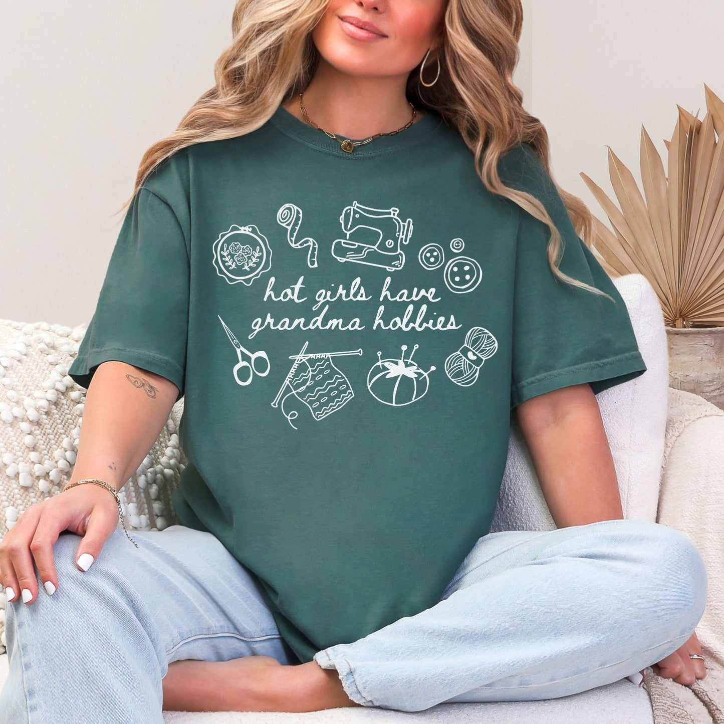 "Hot girls have grandma hobbies" graphic on muted blue-green (blue spruce) t-shirt.