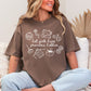 "Hot girls have grandma hobbies" graphic on rich brown (espresso) t-shirt.