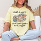 Model wearing a Comfort Colors 1717 t-shirt in a soft pastel yellow (banana) featuring a neutral colored graphic design of a stack of books, a to go coffee, a pair of eye glasses and florals. The cursive script reads "Just a girl who loves books and coffee".