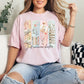 "Just One More Chapter" graphic on soft pink (blossom) t-shirt.