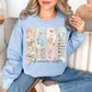 "Just One More Chapter" graphic on pale soft blue (light blue) Sweatshirt.