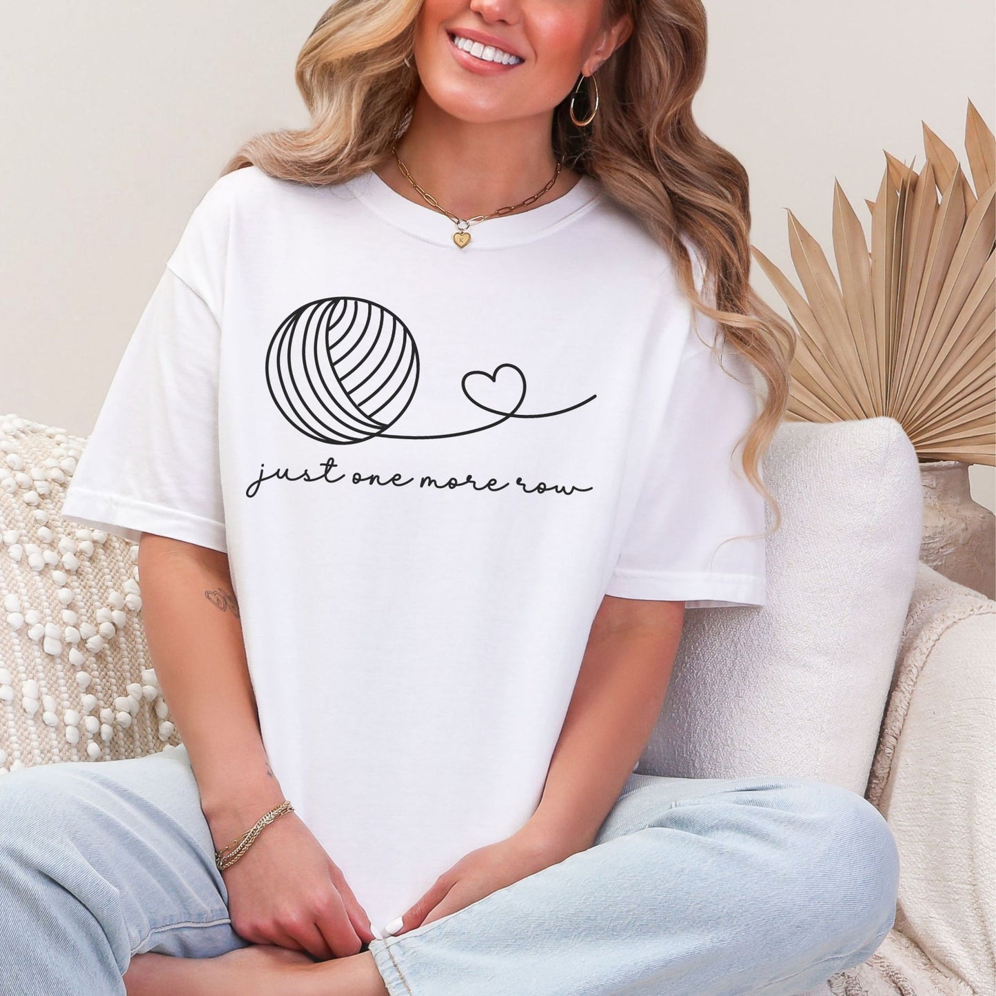 "Just one more row" graphic on bright white (white) t-shirt.