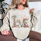 "Love Book Stack" graphic on light warm beige (sand) sweatshirt
